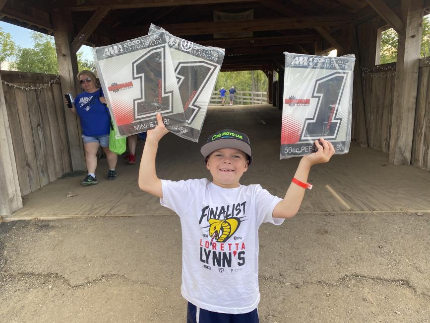 Levi Rains shows off the spoils of victory after winning the 50 Pee Wee, 50 JR classes, and the Mini-E class. Photo: Justin Rains